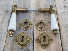 Set of door handles with rosettes - patinated brass 