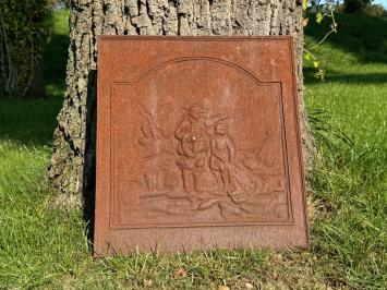 Antique hearth plate with old scene, vintage cast iron, rustic