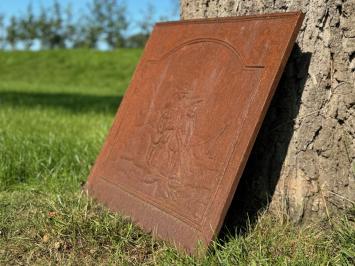 Antique hearth plate with old scene, vintage cast iron, rustic